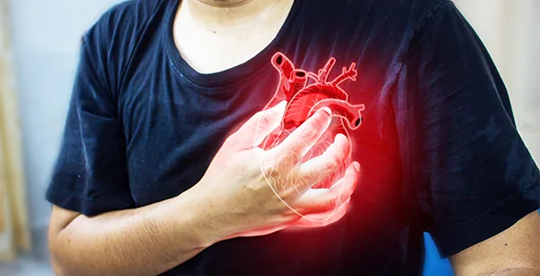 Person experiencing heart pain with red glow effect