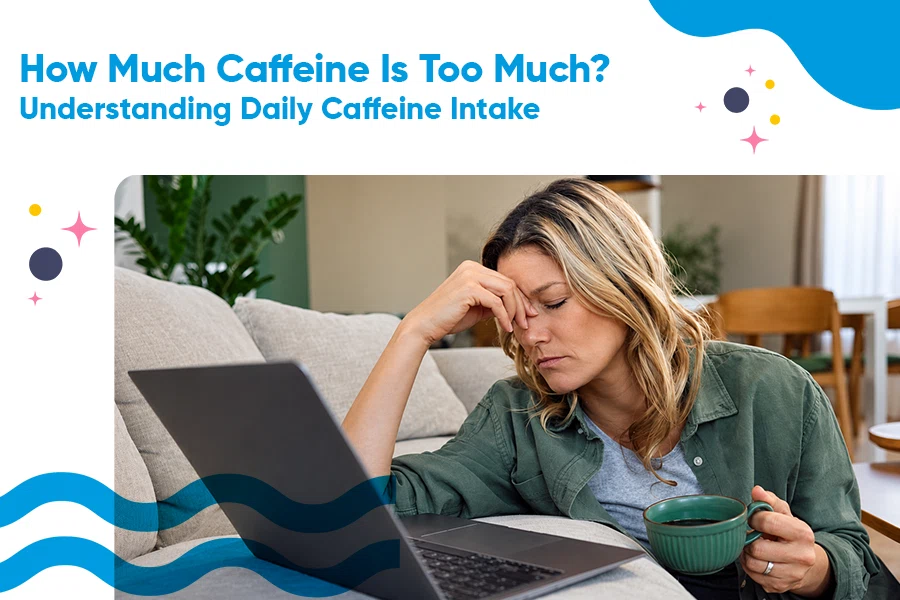 Person holding a cup of coffee while working at a desk
